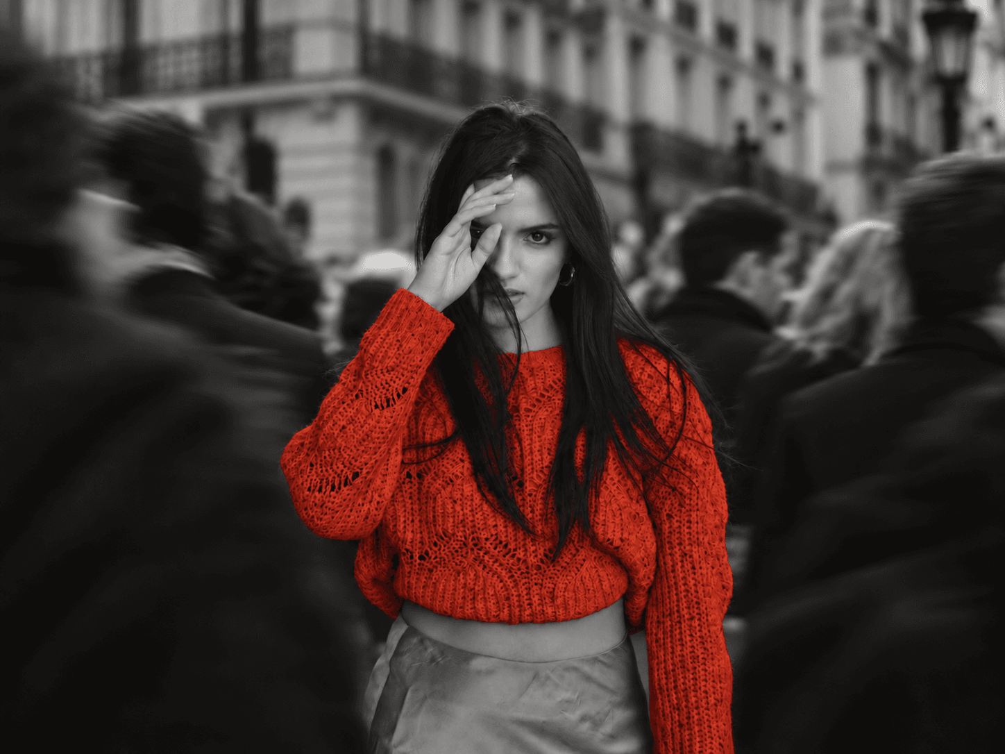 Fatima Zahra El Amri in a red sweater, sharp in a blurred Paris crowd